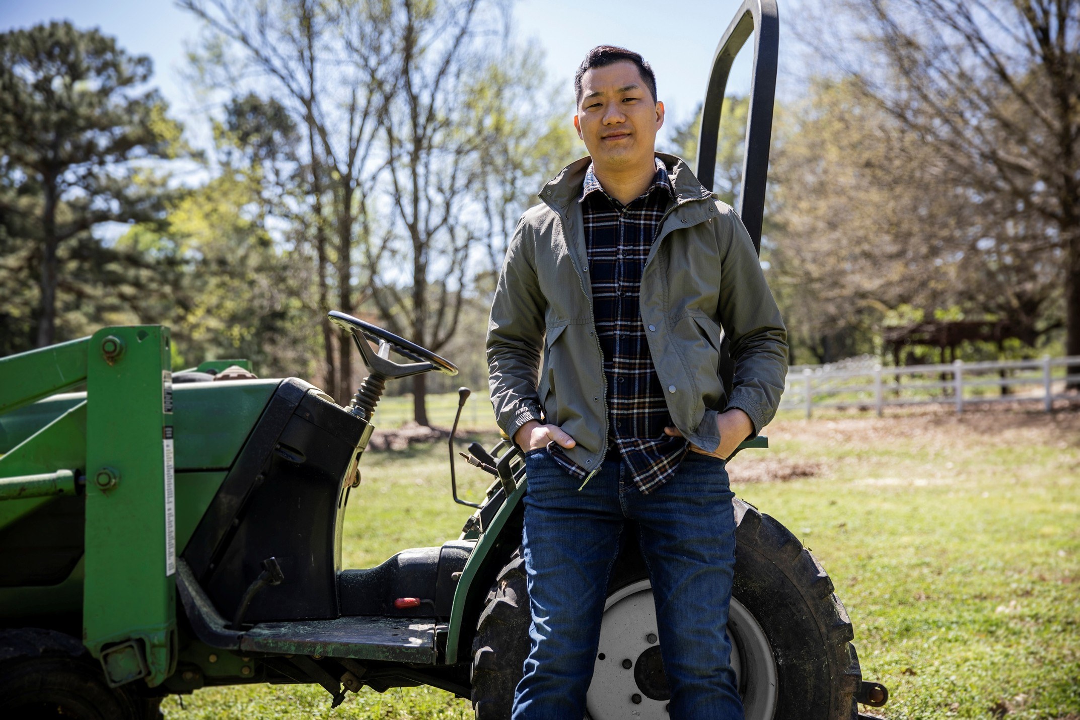 main standing in front of a tractor