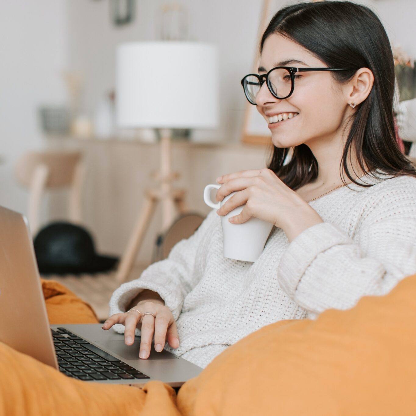 Woman on laptop with coffee