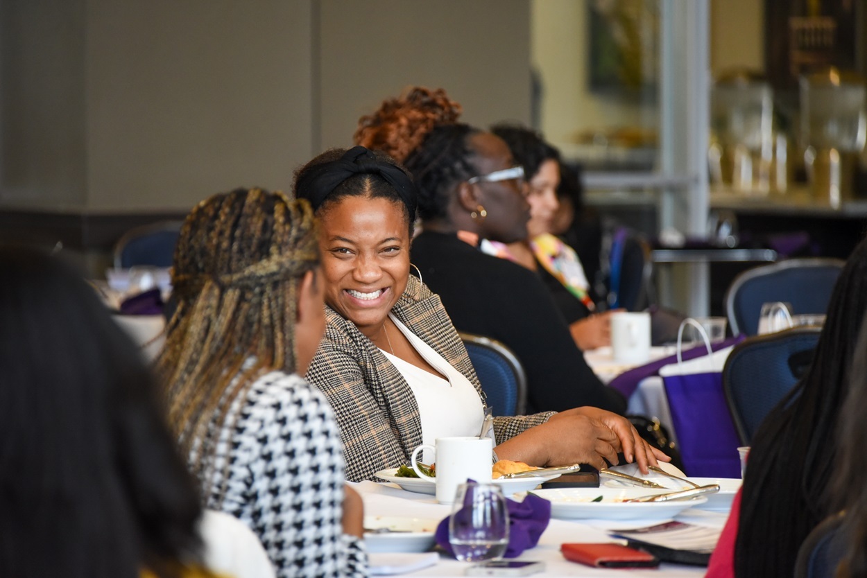 women seated one laughing