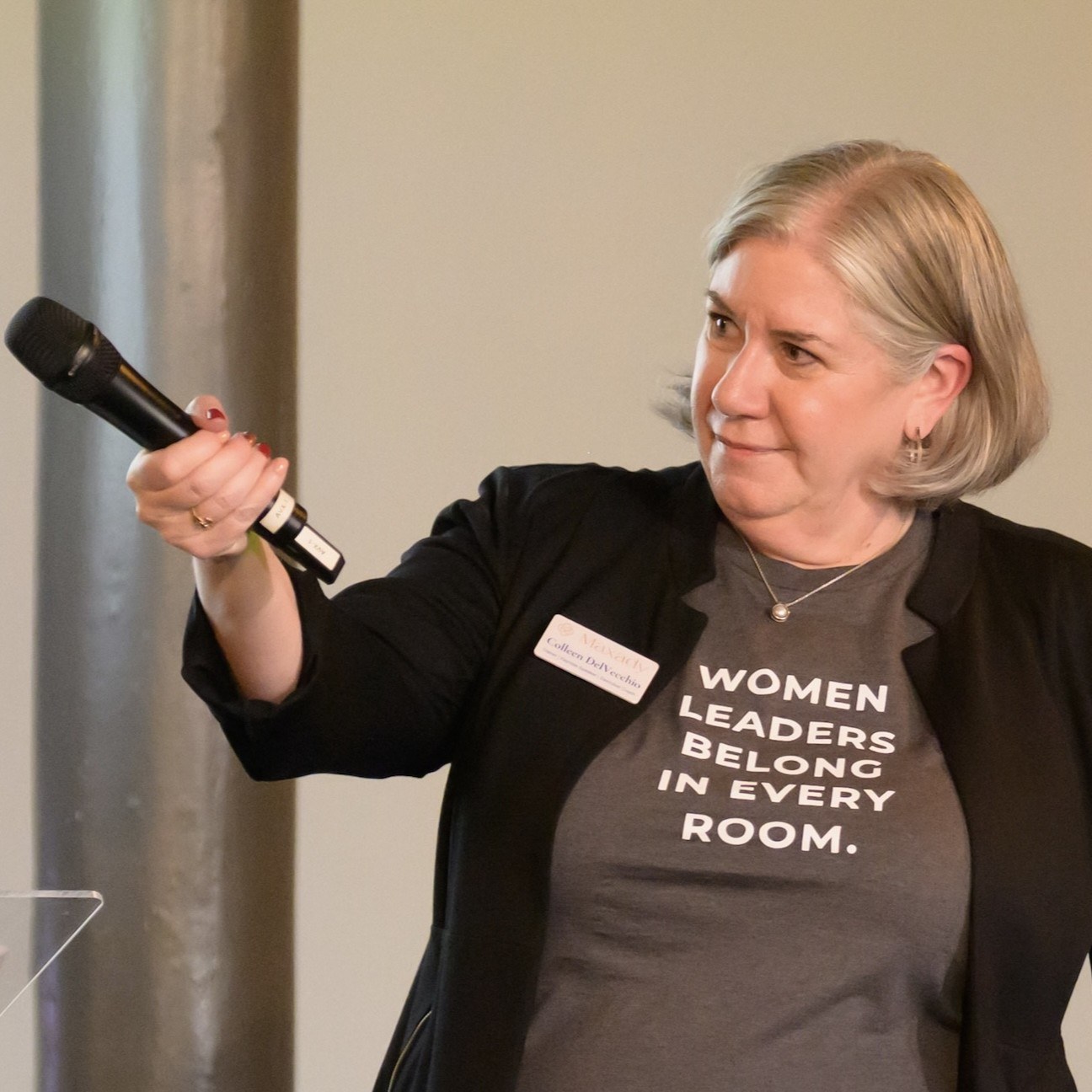 Colleen DelVecchio holding microphone