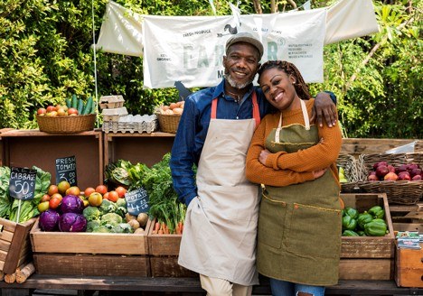 man and women standing together at farm stand